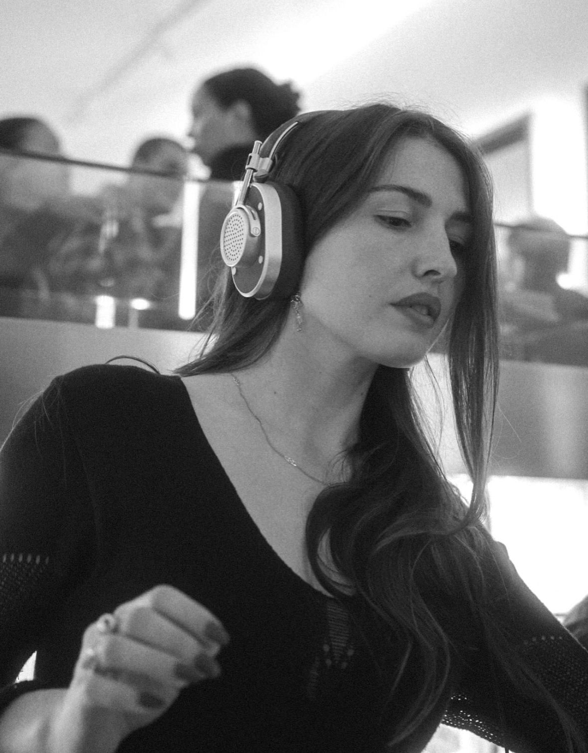 Marieke McKenna behind the decks with headphones on, looking down at the mixer