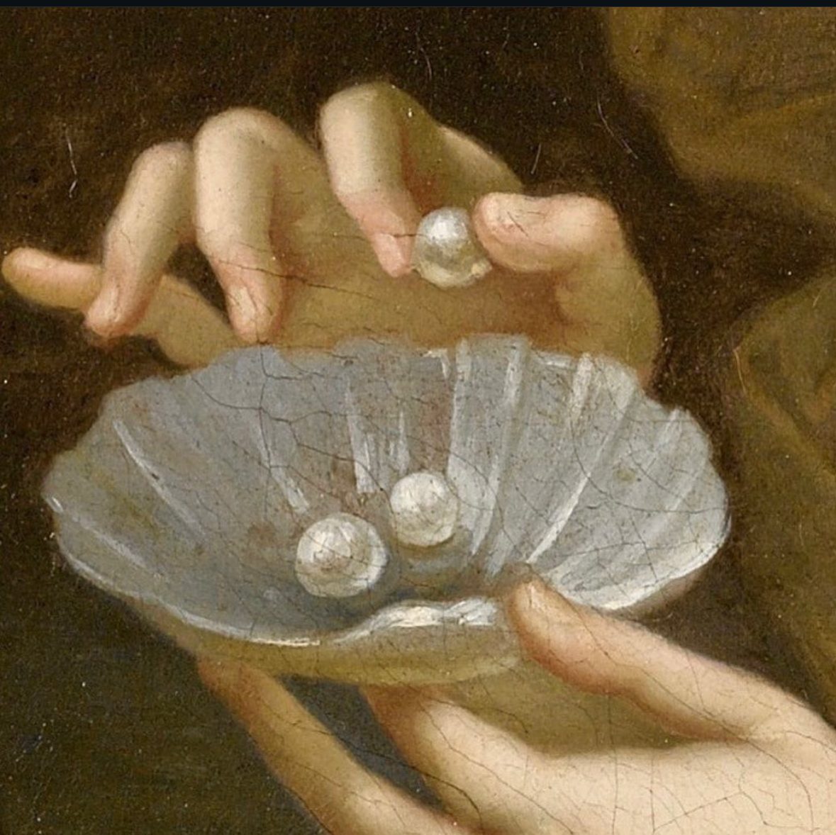 Two painted hands holding an open shell with pearls, one pearl lifted between the fingers