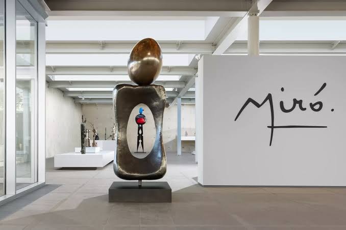 The Miró exhibition at Museum Beelden aan Zee: a tall bronze sculpture in a white gallery, with Miró’s signature on the wall
